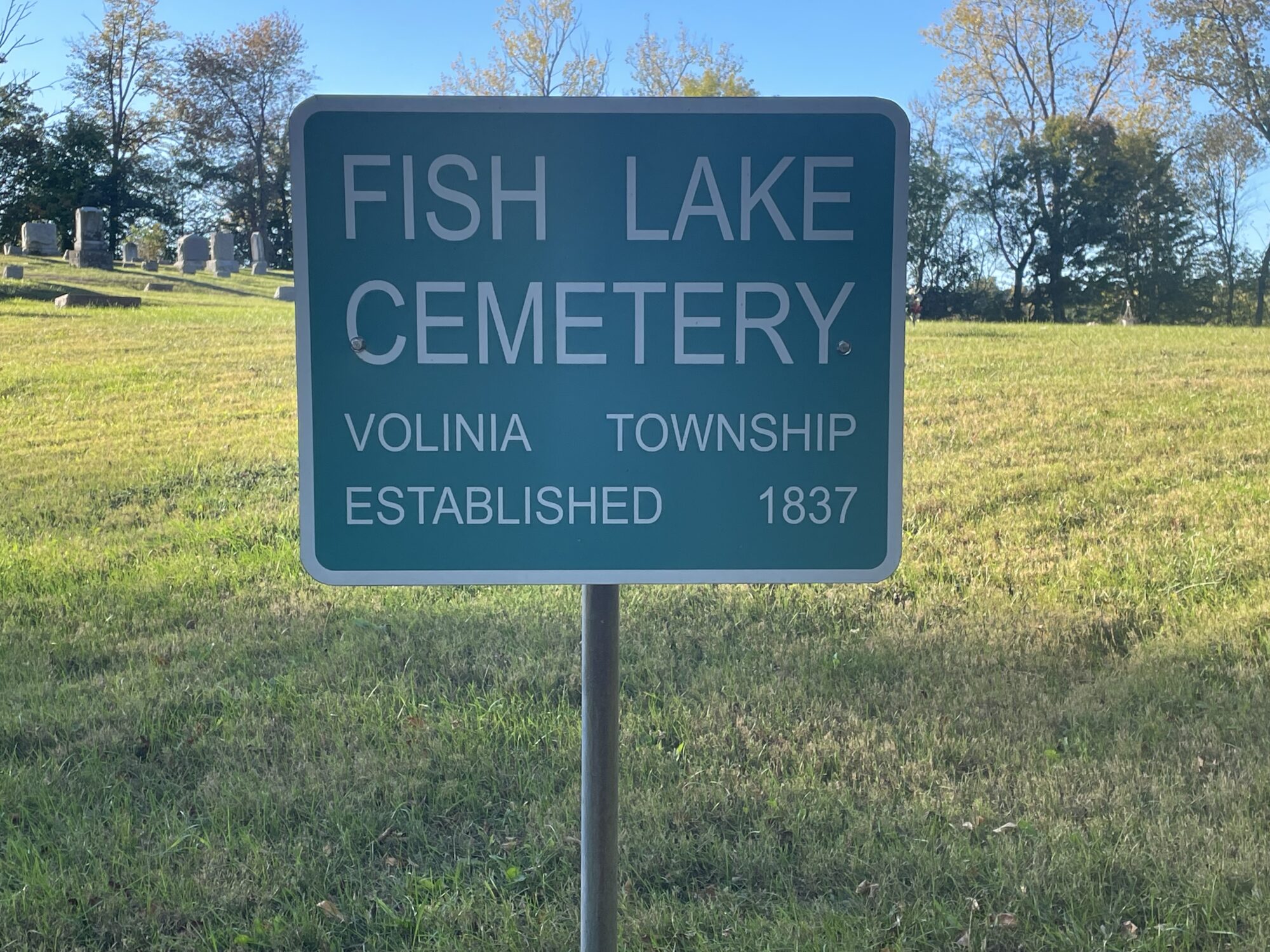 Fish Lake Cemetery sign in grassy area