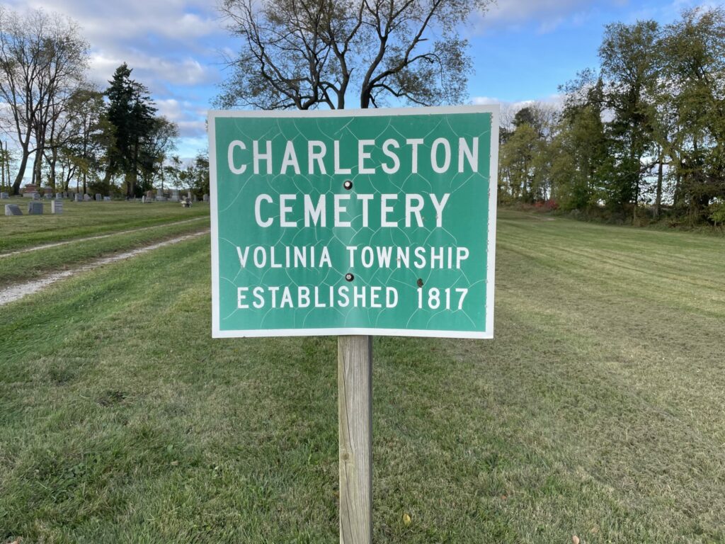 Charleston Cemetery sign, established 1817, grassy grounds